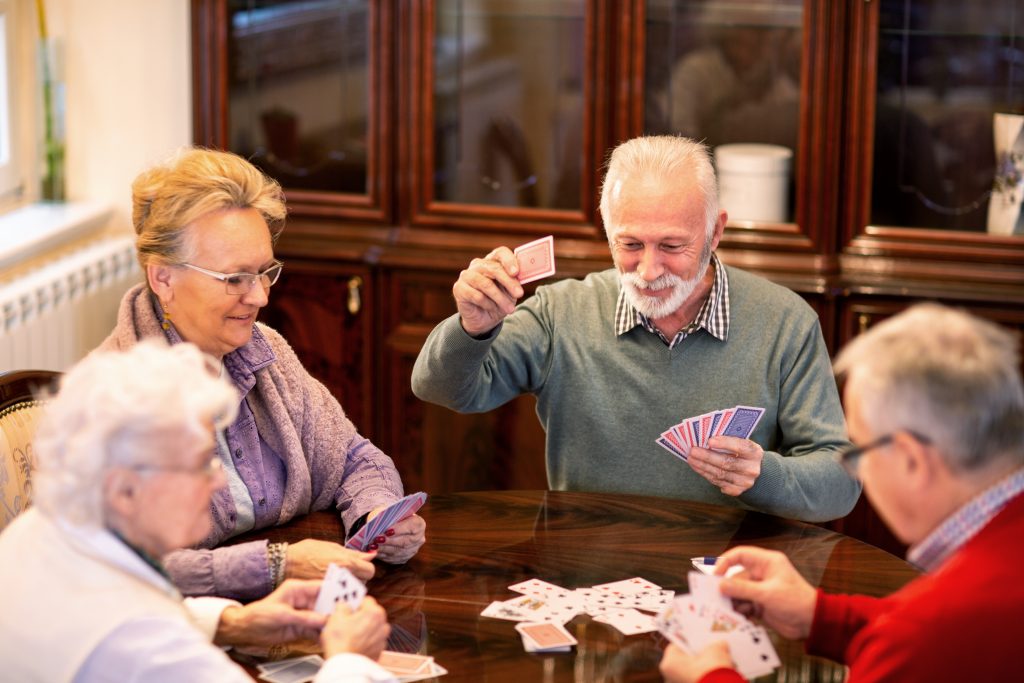A group of senior friends playing cards