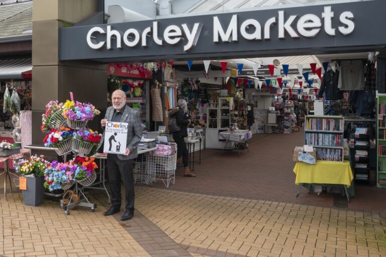 Chorley Market image, with Councillor Danny Gee standing in-front of the market entrance.