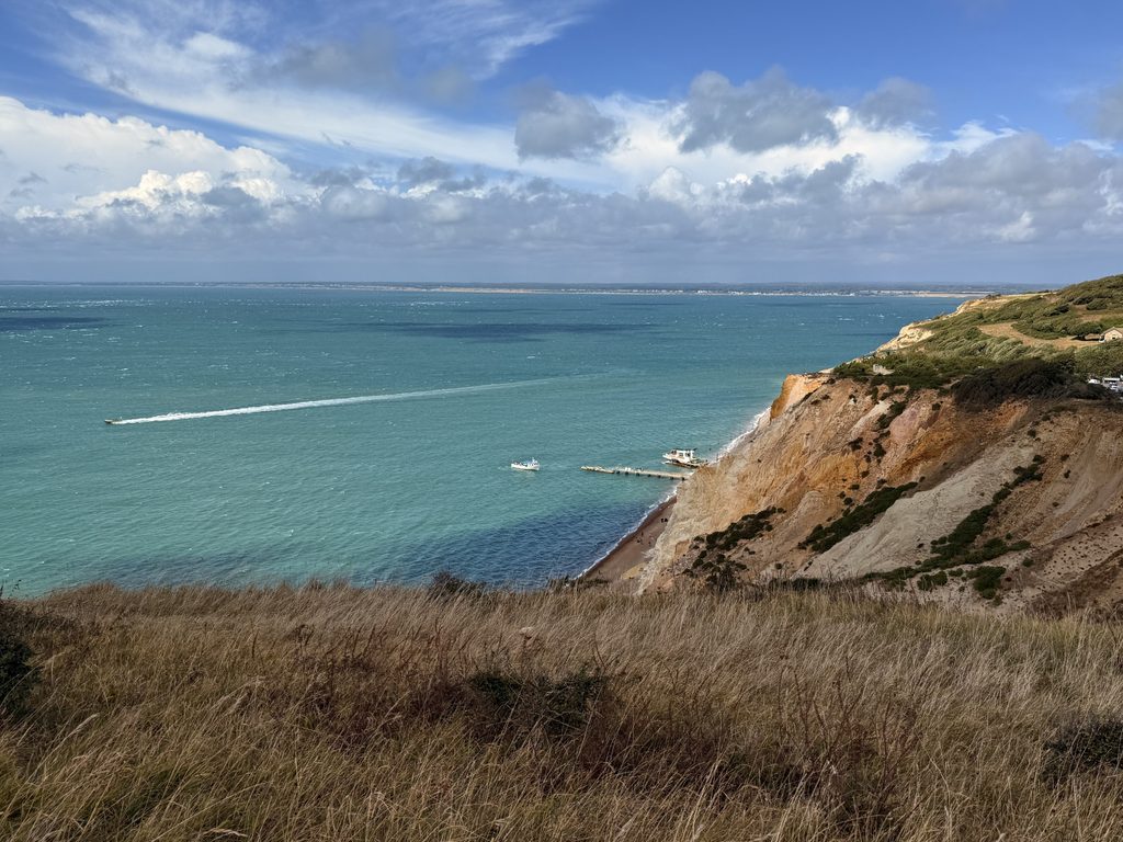 Isle of Wight prostate cancer support group. An image of an ocean view with cliffs to the side and boats on the ocean.