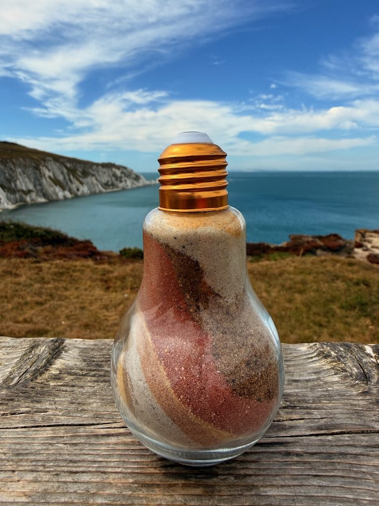 Grains of sand in a light bulb holder as part of the Isle of Wight prostate cancer support group.